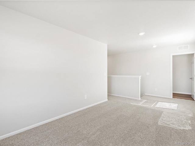 unfurnished room featuring recessed lighting, visible vents, baseboards, and light colored carpet