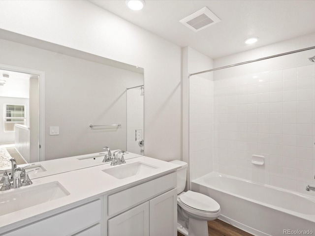 bathroom featuring a sink, visible vents, and toilet