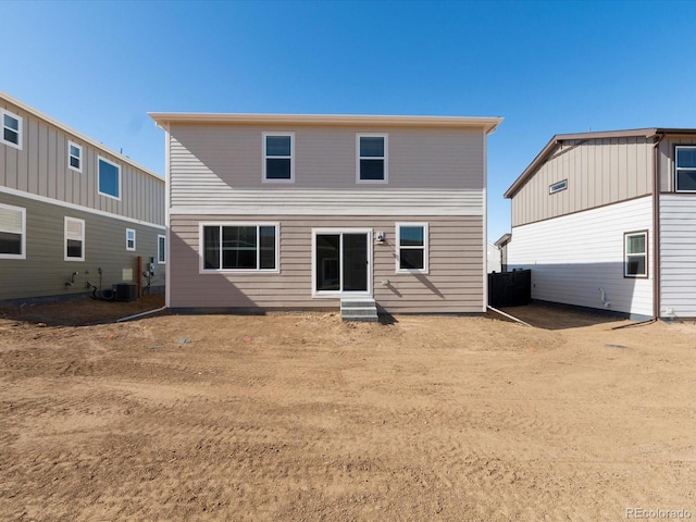 back of property featuring central AC unit and entry steps