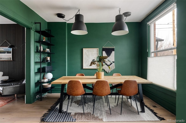 dining space with hardwood / wood-style floors