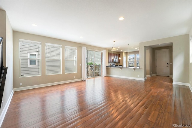 5434 N Xenia St, Denver, CO 80238 - unfurnished living room with dark wood-type flooring and recessed lighting
