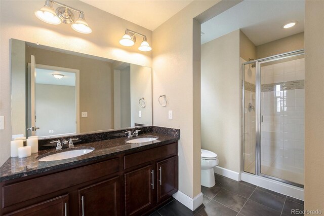 5434 N Xenia St, Denver, CO 80238 - bathroom featuring a stall shower, tile patterned flooring, and double vanity