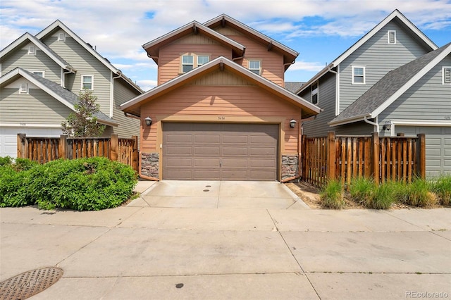 5434 N Xenia St, Denver, CO 80238 - traditional home featuring concrete driveway, stone siding, and an attached garage