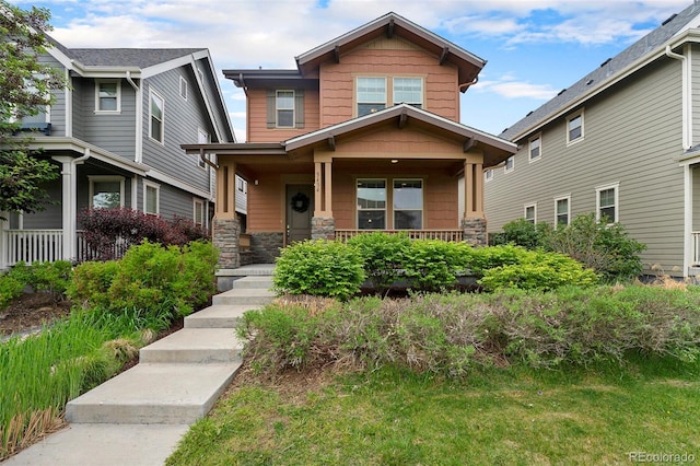 5434 N Xenia St, Denver, CO 80238 - craftsman-style home featuring a porch and stone siding