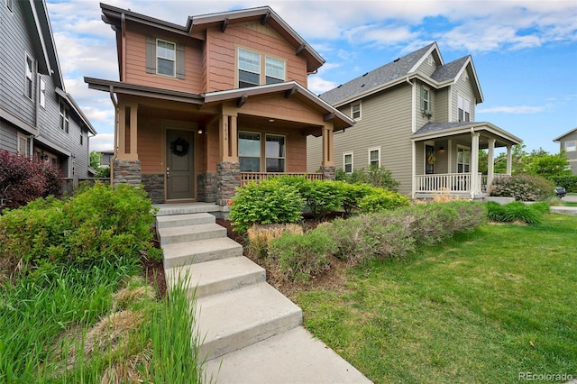 5434 N Xenia St, Denver, CO 80238 - craftsman house featuring a porch, a front lawn, and stone siding