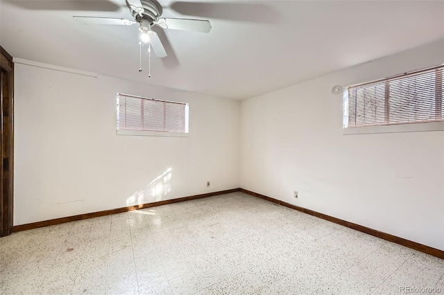 spare room featuring tile patterned floors, baseboards, and ceiling fan