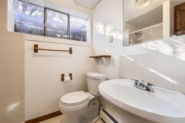 full bathroom with backsplash, toilet, baseboard heating, a shower, and a sink