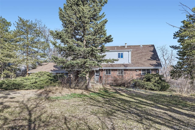 rear view of property with brick siding