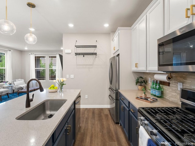 229 W Jamison Ct, Littleton, CO 80120 - kitchen featuring stainless steel appliances, white cabinets, backsplash, dark wood-type flooring, and blue cabinets