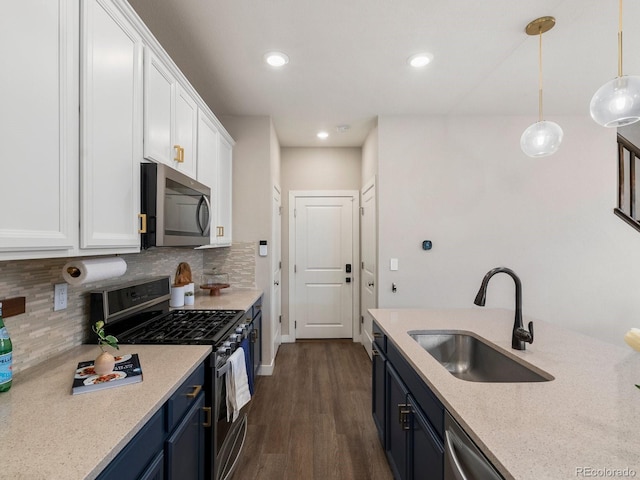 229 W Jamison Ct, Littleton, CO 80120 - kitchen with stainless steel appliances, white cabinetry, tasteful backsplash, dark wood finished floors, and recessed lighting