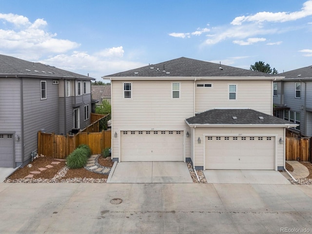 229 W Jamison Ct, Littleton, CO 80120 - rear view of house with driveway and a garage