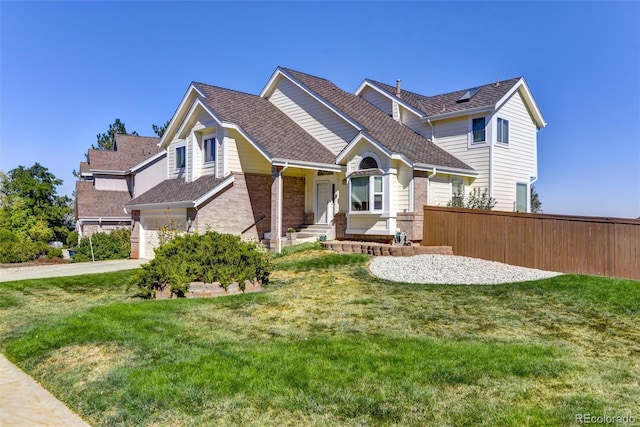 view of front of home with a garage and a front lawn