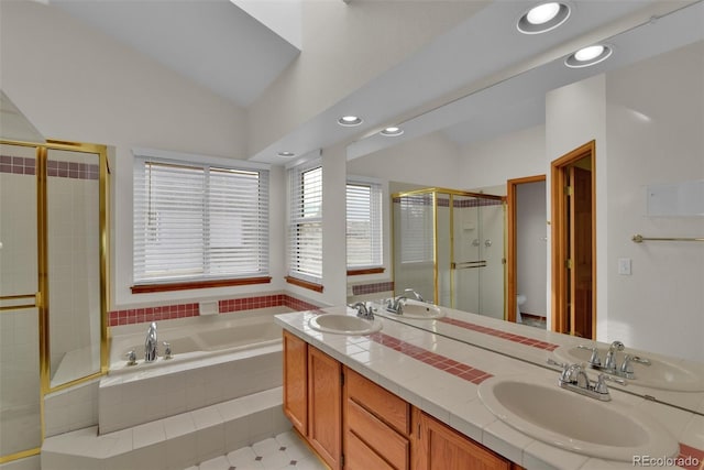 full bathroom featuring vaulted ceiling, separate shower and tub, vanity, and toilet