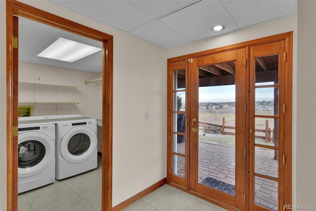 laundry area with light tile patterned flooring and independent washer and dryer