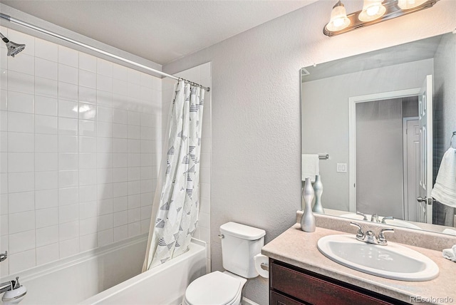 bathroom with shower / bath combo, a textured wall, vanity, and toilet
