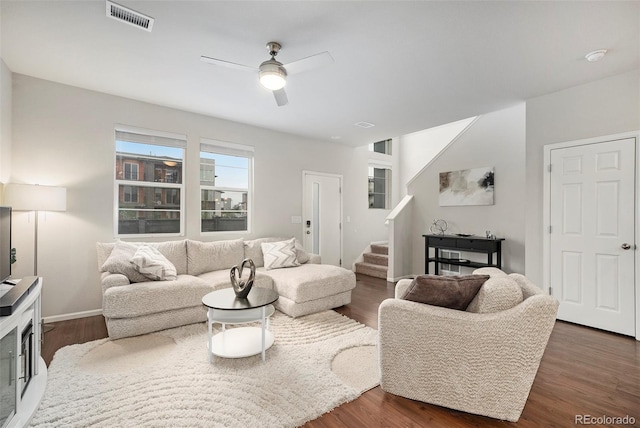 16141 Bolling Dr, Denver, CO 80239 - living room featuring a ceiling fan, stairway, dark wood-style floors, and baseboards