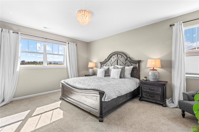 bedroom with baseboards, carpet, and visible vents