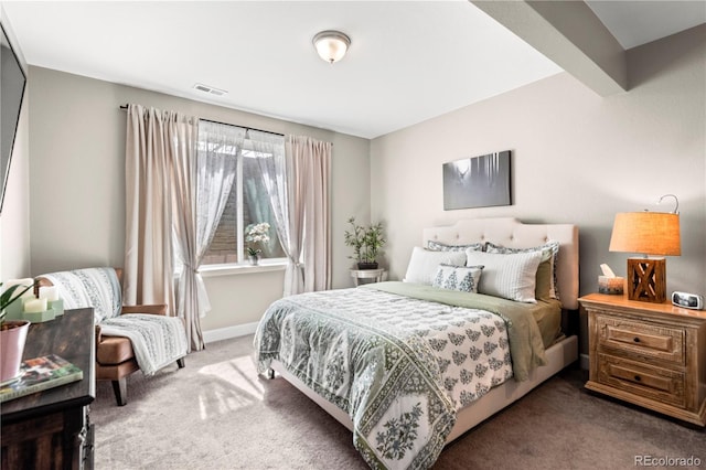 carpeted bedroom featuring baseboards and visible vents