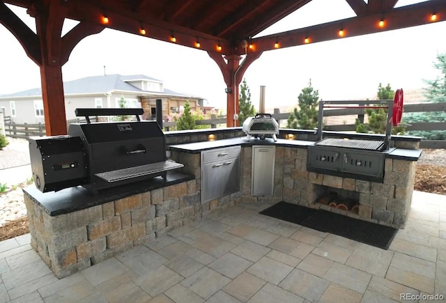 view of patio / terrace featuring area for grilling, a gazebo, and fence