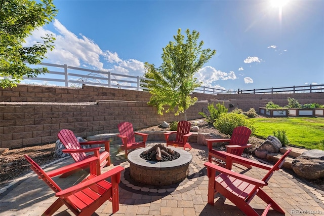 view of patio featuring a fire pit and fence
