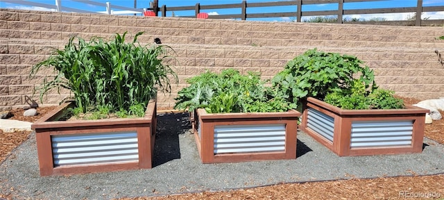 view of patio / terrace with fence and a vegetable garden