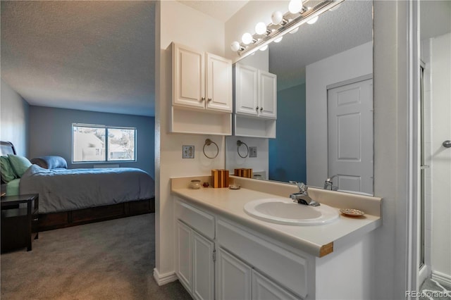 full bath with ensuite bathroom, a textured ceiling, and vanity