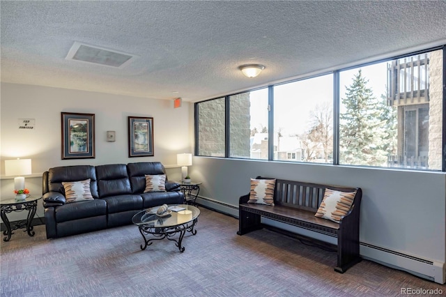 carpeted living area featuring visible vents, a baseboard heating unit, and a textured ceiling