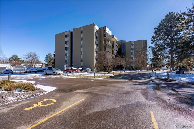 view of building exterior featuring uncovered parking