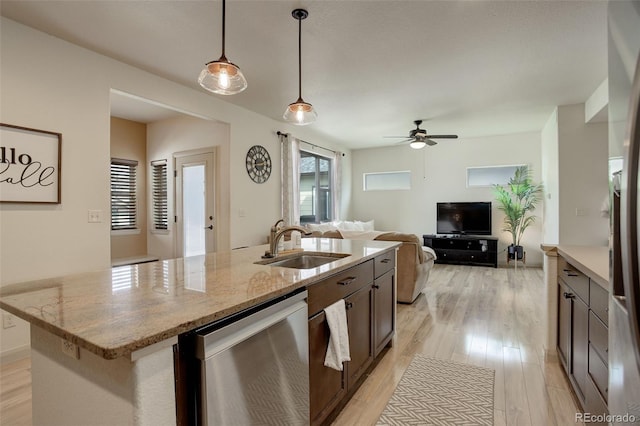 kitchen featuring light stone countertops, decorative light fixtures, light hardwood / wood-style floors, stainless steel dishwasher, and ceiling fan