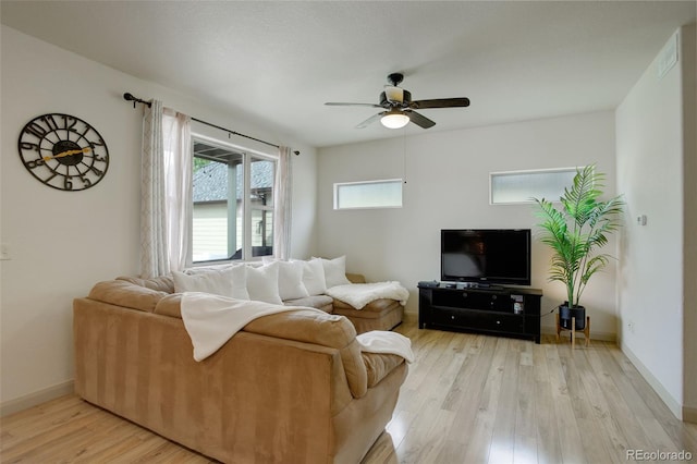 living room featuring light hardwood / wood-style flooring and ceiling fan