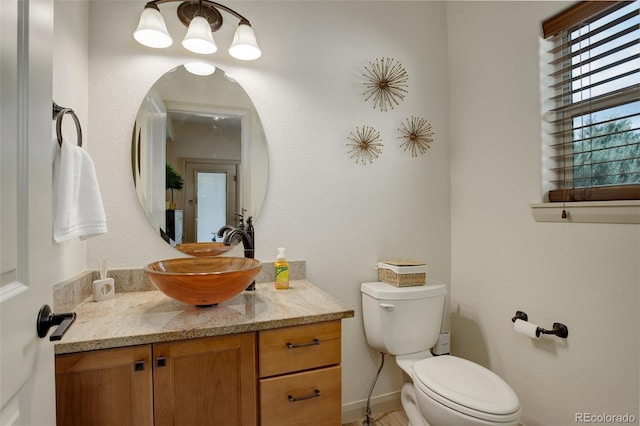 bathroom with toilet and vanity