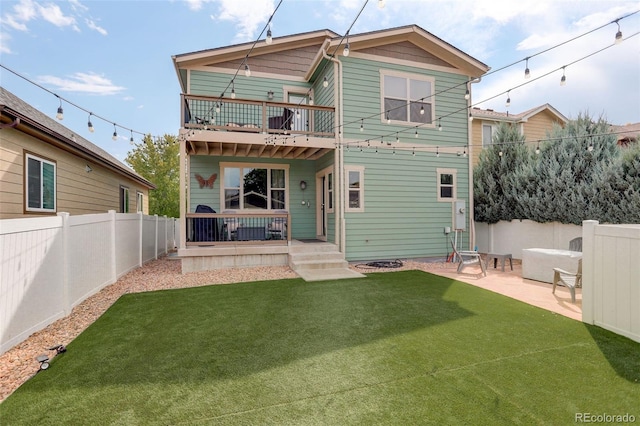 back of property featuring a patio area and a yard