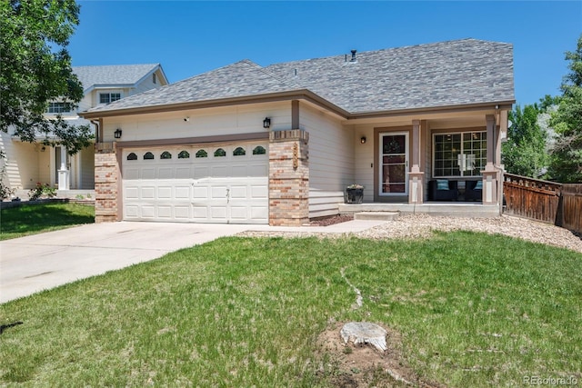 5033 Goshawk Ct, Brighton, CO 80601 - view of front of property with driveway, a garage, brick siding, and a shingled roof