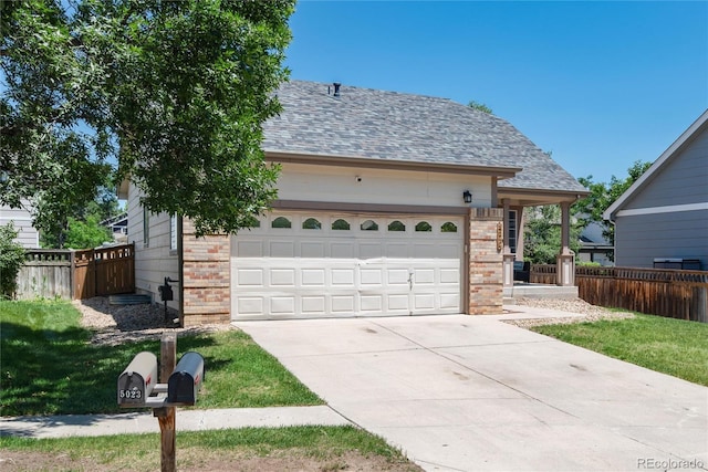 5033 Goshawk Ct, Brighton, CO 80601 - view of front of home featuring brick siding, driveway, an attached garage, and a shingled roof