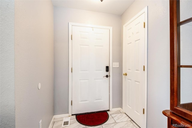 5033 Goshawk Ct, Brighton, CO 80601 - doorway to outside featuring baseboards and light marble finish floors