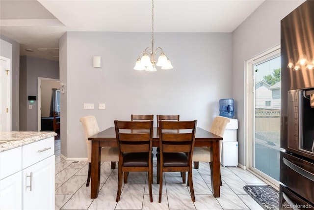 5033 Goshawk Ct, Brighton, CO 80601 - dining space with a chandelier and light marble finish flooring