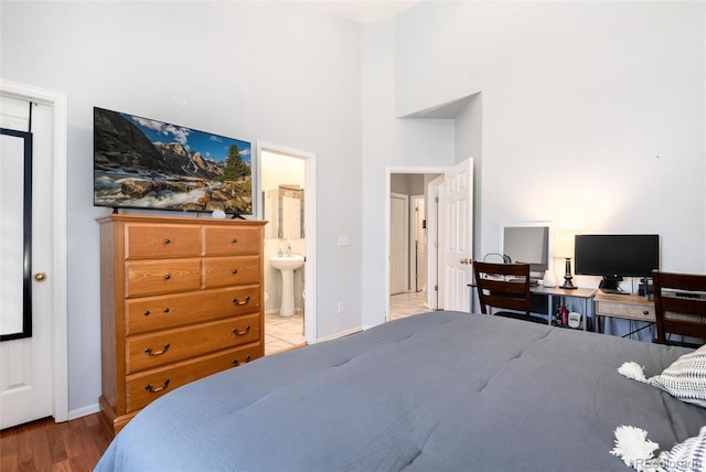 5033 Goshawk Ct, Brighton, CO 80601 - bedroom with wood finished floors, a high ceiling, and ensuite bath