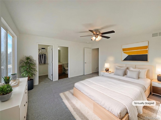 bedroom featuring ceiling fan, carpet flooring, connected bathroom, a spacious closet, and a closet