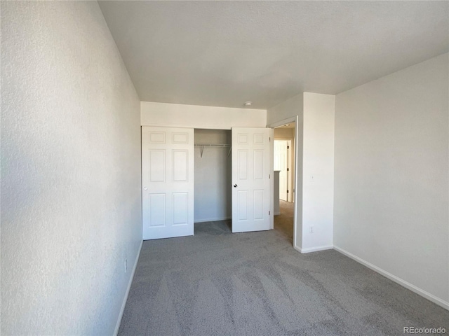 unfurnished bedroom with carpet flooring and a closet