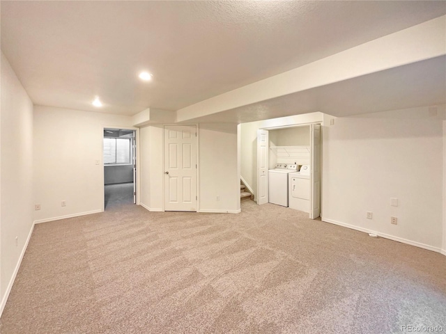 basement featuring light colored carpet and washer and dryer