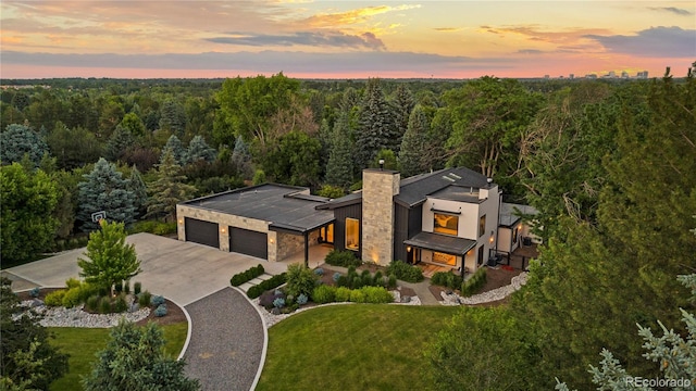 birds eye view of property featuring a view of trees