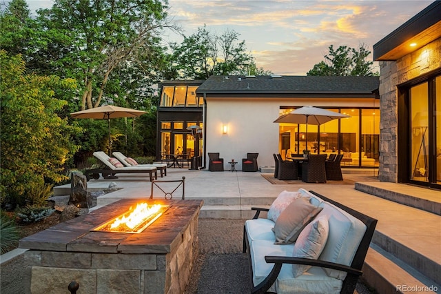 view of patio / terrace with an outdoor living space with a fire pit and outdoor dining space