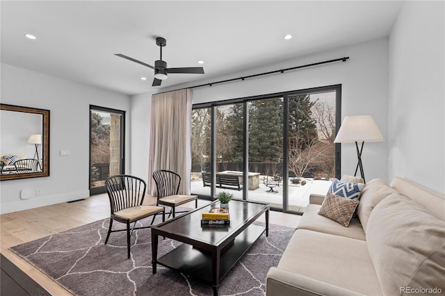 living area featuring recessed lighting, baseboards, ceiling fan, and wood finished floors