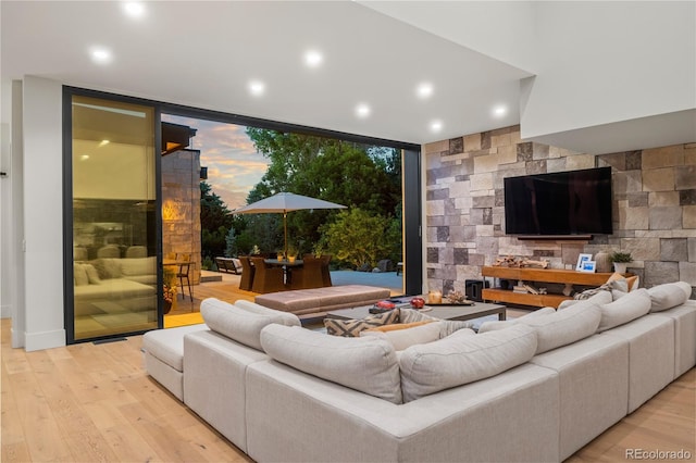 living area with light wood-style flooring, recessed lighting, and expansive windows