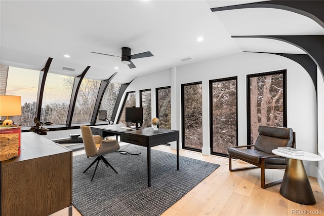 home office with visible vents, a ceiling fan, recessed lighting, light wood-style floors, and vaulted ceiling