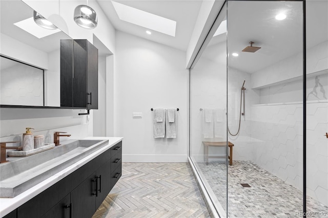 full bath featuring baseboards, walk in shower, recessed lighting, a skylight, and vanity