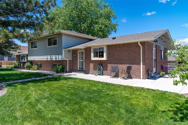 16225 W 74th Dr, Arvada, CO 80007 - split level home featuring brick siding, a patio, and a front yard