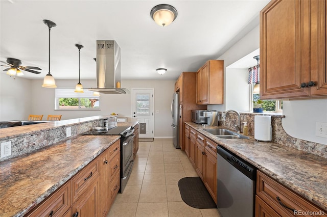 16225 W 74th Dr, Arvada, CO 80007 - kitchen with stainless steel appliances, island exhaust hood, a sink, brown cabinetry, and a ceiling fan