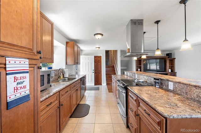 16225 W 74th Dr, Arvada, CO 80007 - kitchen featuring appliances with stainless steel finishes, island range hood, a sink, brown cabinets, and decorative light fixtures