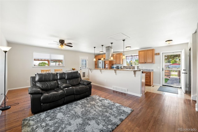 16225 W 74th Dr, Arvada, CO 80007 - living area featuring light wood finished floors, ceiling fan, and baseboards